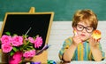 School lunch. Schoolboy in classroom eating apple. Healthy food for kids. Elementary school kid sitting at desk. Royalty Free Stock Photo