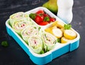 Healthy lunch box with tortilla wraps, tomatoes, banana.