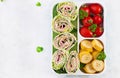 Healthy lunch box with tortilla wraps, tomatoes, banana.