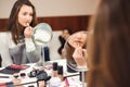 School of makeup. Make up artist doing professional make up of young woman. Royalty Free Stock Photo