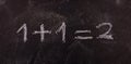 Simple equation 1+1=2 isolated, on blackboard background.