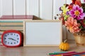 School mockup. back to school. an empty frame, a bouquet of dahlias, an alarm clock Royalty Free Stock Photo