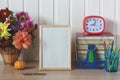 School mockup with an empty frame, Alarm clock, bouquet and books Royalty Free Stock Photo