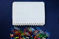 School notebook on a blue background, spiral notepad on a dack blue background with selected area and colorful clips