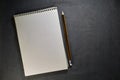 School notebook on a gray background, spiral notepad on a table