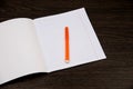 School notebook paper. orange markers. Notebook in line and pencil. open notebook on a brown background. planning. stationery