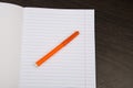 School notebook paper. orange markers. Notebook in line and pencil. open notebook on a brown background. planning. stationery