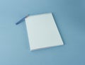 school notebook on a spiral with a blue pencil close-up Royalty Free Stock Photo