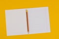 School notebook on a yellow background with copy space for text and pencil. Back to school. Blank sheet of paper with oblique line Royalty Free Stock Photo