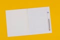 School notebook on a yellow background with copy space for text and transparent pen. Back to school. Blank sheet of paper Royalty Free Stock Photo