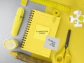 School or office accessories on yellow and gray background