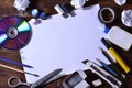 A school or office still life with a white blank sheet of paper and many office supplies. The school supplies lie on a brown wood Royalty Free Stock Photo