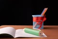 School and office supplies on classroom table in front of blackboard. View with copy space Royalty Free Stock Photo