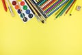 School and office supplies ready for pupils on yellow background Royalty Free Stock Photo