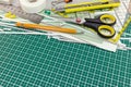 School or office supplies and tools on cutting mat Royalty Free Stock Photo