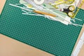 school or office supplies and tools on green cutting mat background Royalty Free Stock Photo