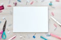 School office supplies on wooden background. Back to school concept. White board with hands for copy space. Top view Royalty Free Stock Photo