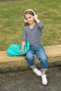 School out, summer in. Little kid listen to music in headphones outdoors. Summer vacation. School holidays. Musical Royalty Free Stock Photo