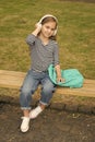 School out, summer in. Little kid listen to music in headphones outdoors. Summer vacation. School holidays. Musical Royalty Free Stock Photo