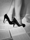 Girl in high heels stands on the books