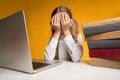 Elementary School Girl Crying Covering Face With Hands, Yellow Background