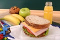 School packed lunch ham and cheese sandwich on classroom table or desk Royalty Free Stock Photo