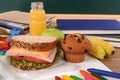 School packed lunch, sandwich, apple, drink on classroom desk or table Royalty Free Stock Photo