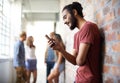 School, phone and relax with man in hallway for social media, technology or internet. Eduction, learning and scholarship