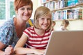 School Pupil With Teacher Using Laptop Computer In Classroom Royalty Free Stock Photo