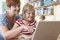 School Pupil With Teacher Using Laptop Computer In Classroom Royalty Free Stock Photo