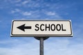 School road sign, arrow on blue sky background Royalty Free Stock Photo