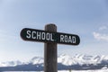 School Road Sign in Mountain Town Royalty Free Stock Photo