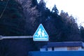 School roadside warning sign mounted on brown steel beam. Mountains, blue sky and bright sunlight in background. Royalty Free Stock Photo