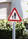School Safety Zone Roadside Warning Sign - black silhouettes on a white background in a red triangle Royalty Free Stock Photo