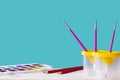 School set of pencils, paints, glass brush, on a blue background with space for text. back to school. office supplies, stationery Royalty Free Stock Photo