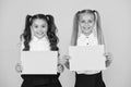 School socialization. Girls school uniform hold poster. Back to school concept. Schoolgirls show poster. Social poster