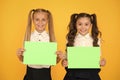 School socialization. Girls school uniform hold poster. Back to school concept. Schoolgirls show poster. Social poster