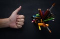 School Stationary in Basket and Thumb up Hand on Blackboard Royalty Free Stock Photo