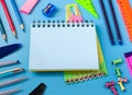 School stationary on blue background Notebook pens pencils. Generative AI Royalty Free Stock Photo