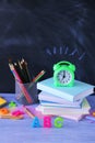 School stationery, books, alarm clock, home learning concept