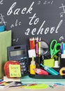 School stationery laid on a background of chalkboard