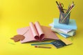 School stationery, open book, heart shaped pages, alarm clock on desk Royalty Free Stock Photo