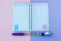 School stationery with stylish unicorn pen on a pink and purple duotone background Royalty Free Stock Photo