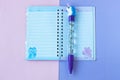 School stationery with stylish unicorn pen on a pink and purple duotone background Royalty Free Stock Photo