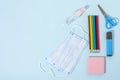 School stationery supplies, medical masks and hand gel sanitizer, keep your distance, open school, go back to school for the Royalty Free Stock Photo