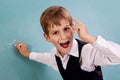 School student writing on blackboard at school Royalty Free Stock Photo