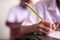 School Students hands taking exams and writing examination with holding pencil in classroom Royalty Free Stock Photo