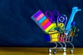 School and study supplies in shopping cart Royalty Free Stock Photo