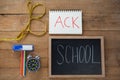 School supplies, alarm clock and measuring tape on wooden table