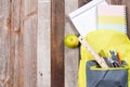 School supplies in backpack on wooden background. Royalty Free Stock Photo